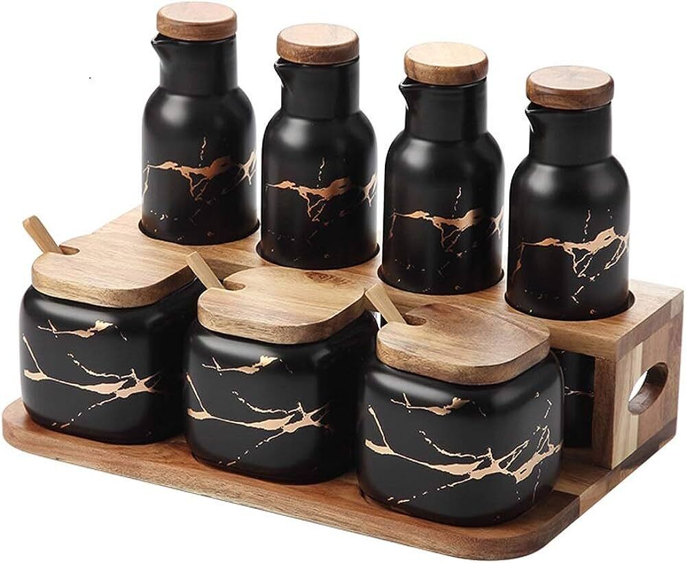 Set of black ceramic containers with wooden lids on a wooden tray