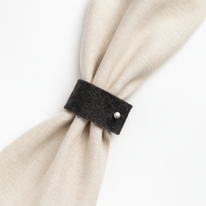 Minimalist black felt napkin rings with a silver accent.