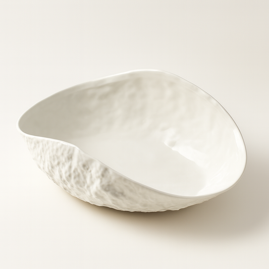 White ceramic bowl with textured surface on a light beige background