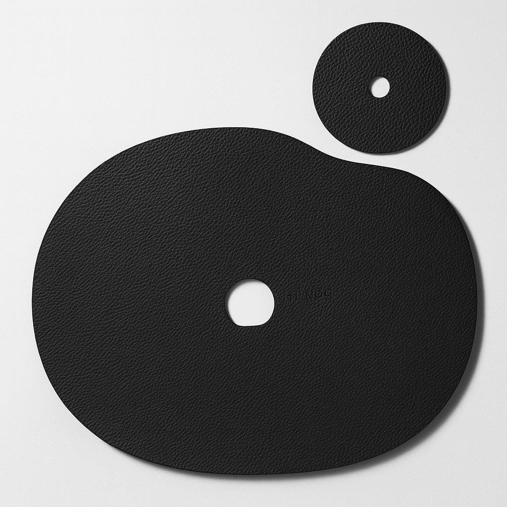 Black natural leather placemat and coaster set with a hole in the center.
