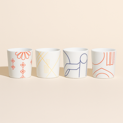 Set of four porcelain cups with decorative patterns.