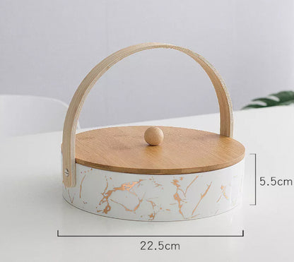 Decorative box with wooden lid and handle on a light gray background