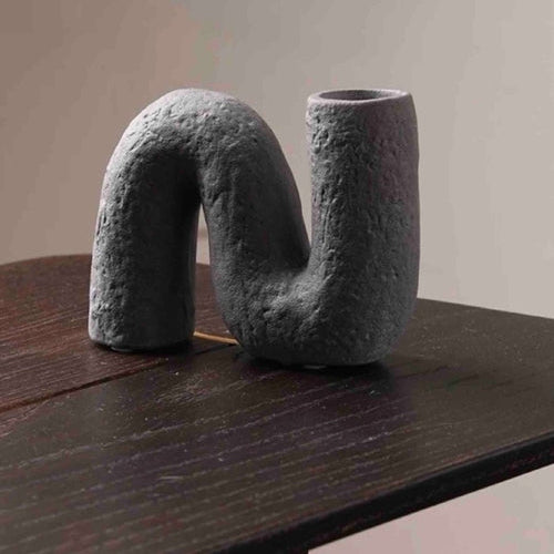 Abstract sculpture on a wooden surface with 'STYLE A' text above.