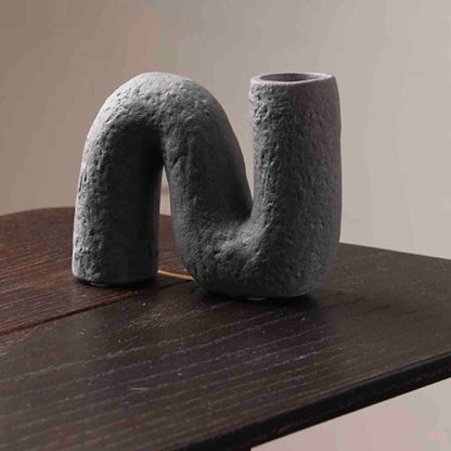 Abstract sculpture on a wooden surface with 'STYLE A' text above.