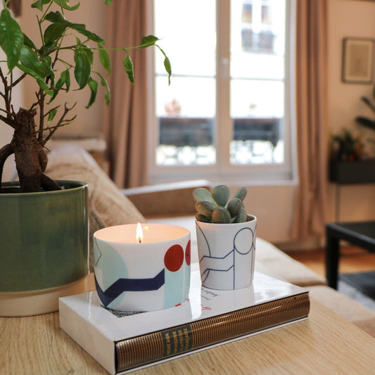 Beaubourg scented candle styled with books and ceramics in a neutral-toned interior